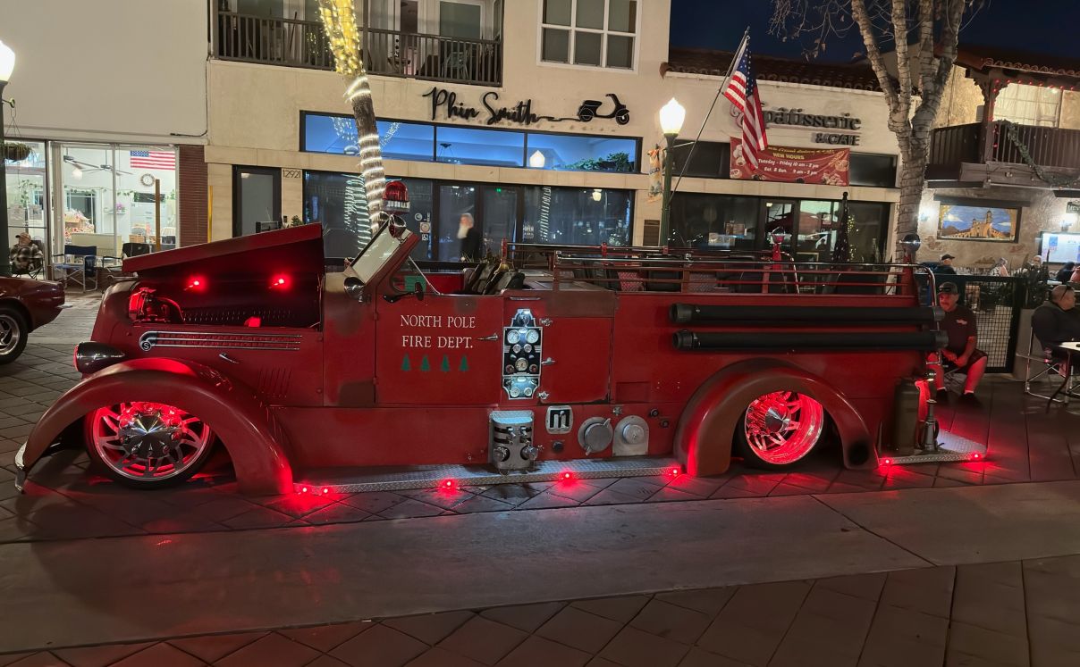 Custom vintage fire truck parked at night meet